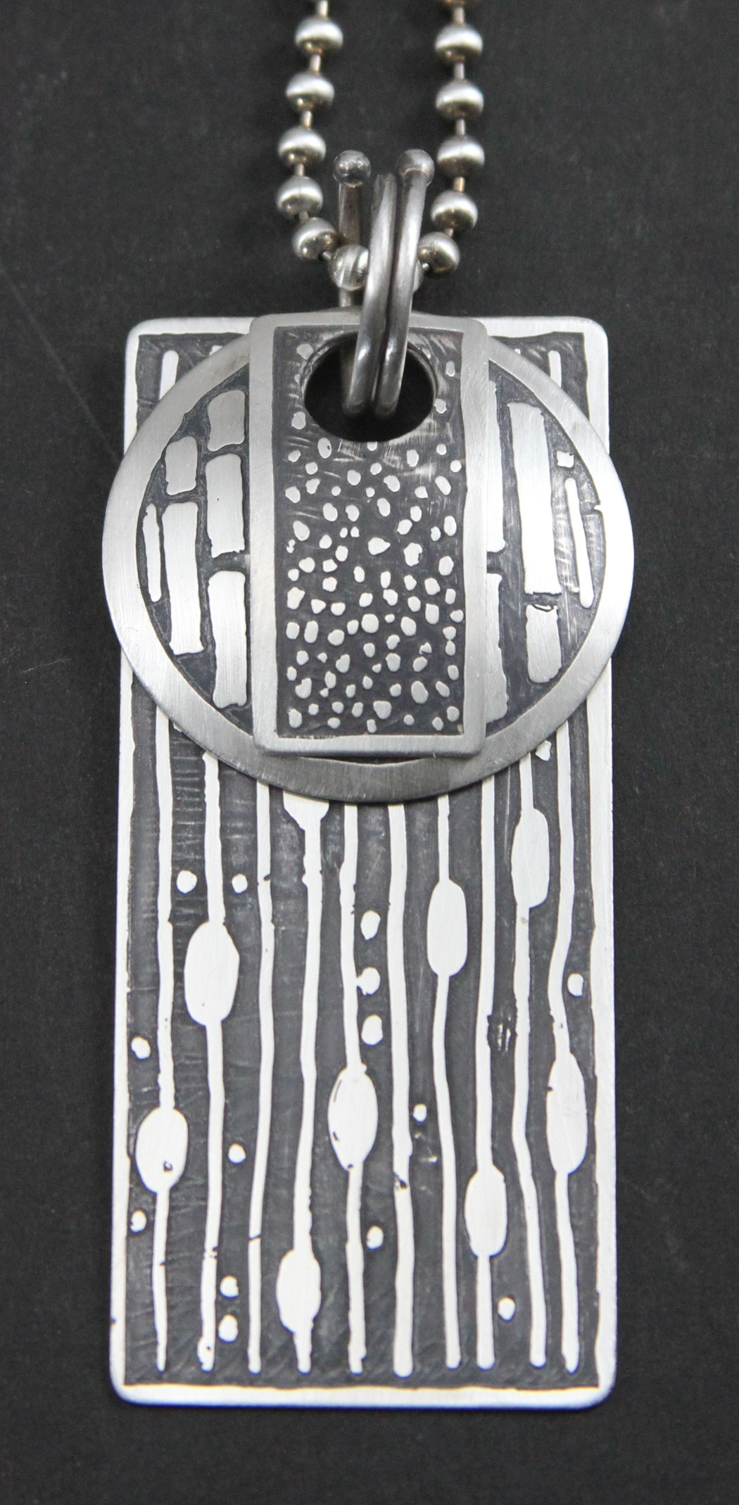 Closeup of a metal pendant with different patterns on it