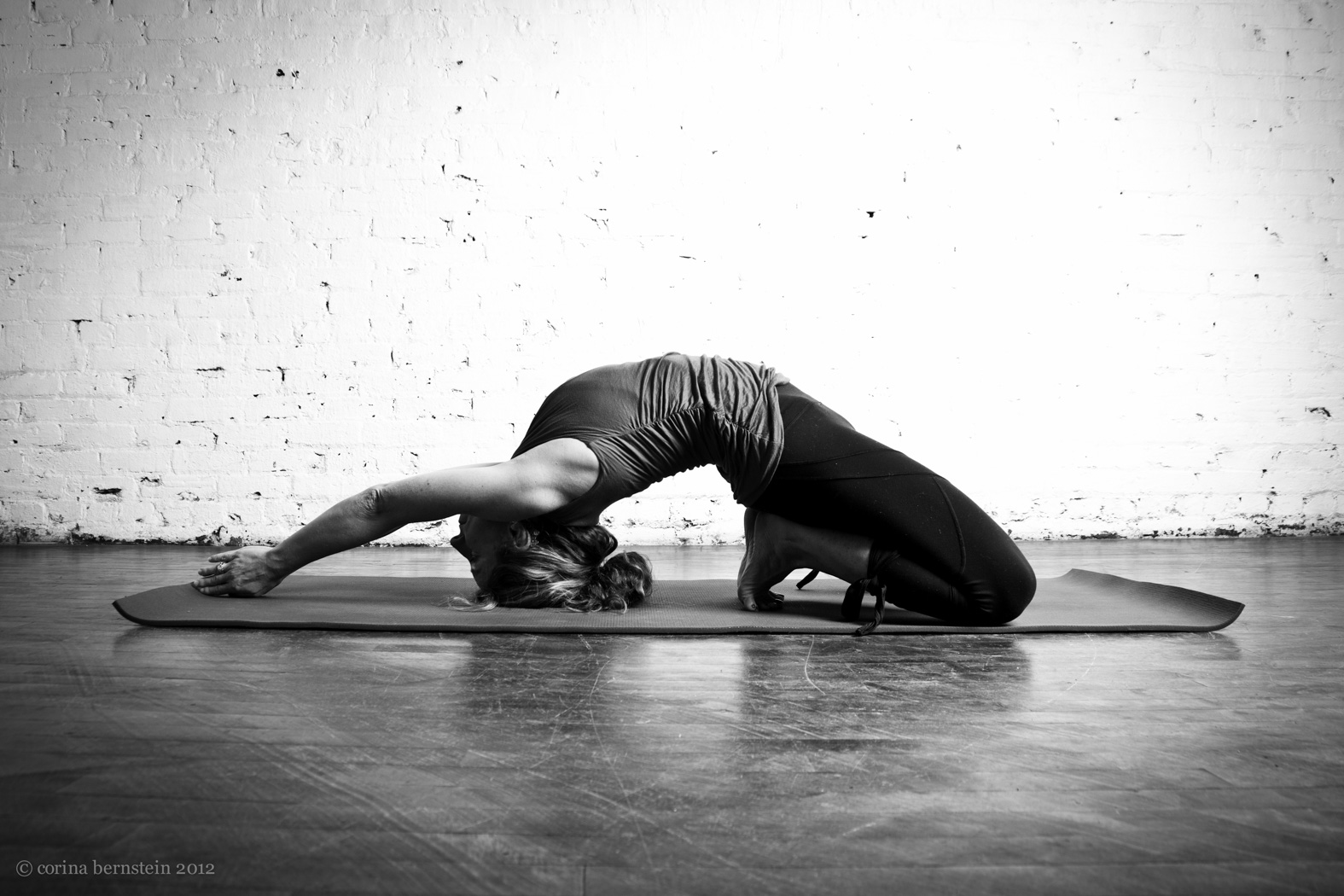 Black and white portrait of a woman doing a yoga pose