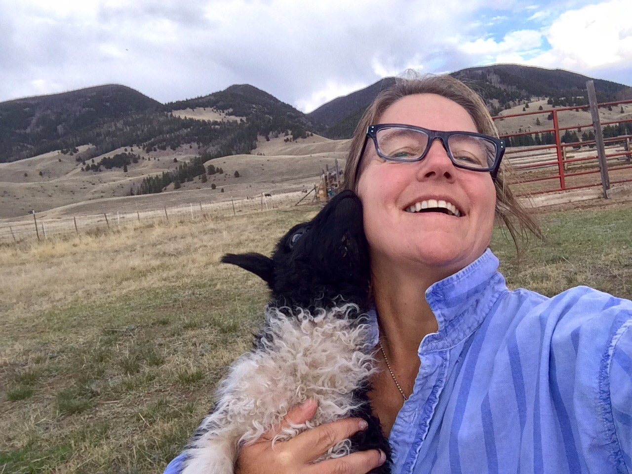 View of a happy woman holding a little sheep