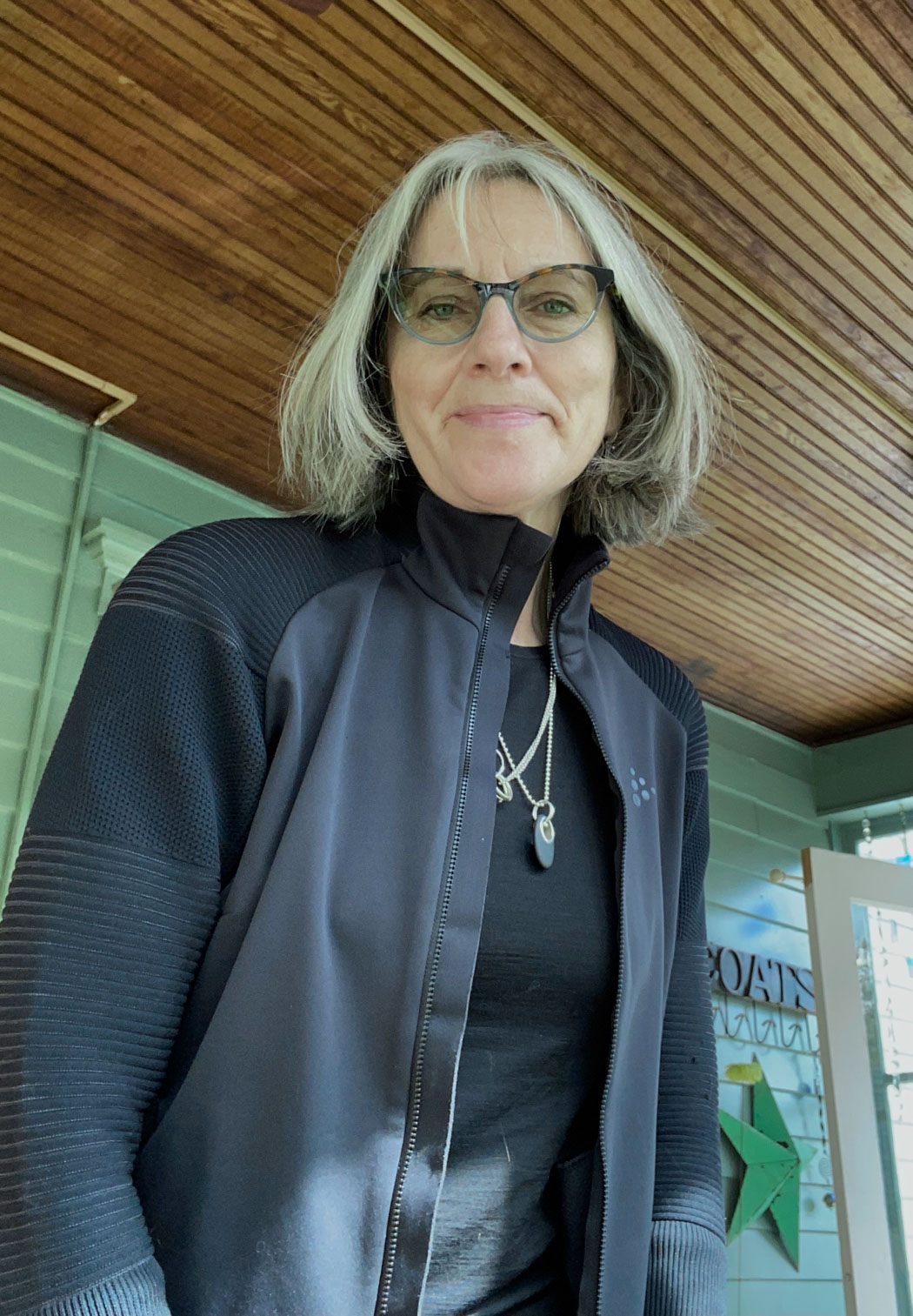 View of a mature lady wearing glasses and a black jacket