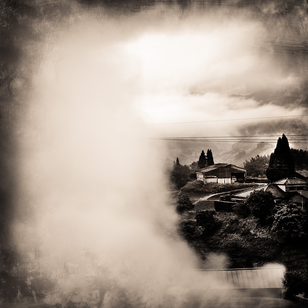 A general black and white portrait of a town with smoke 
