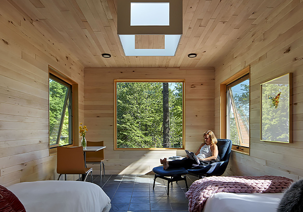 Internal view of a wooden room and a person reading peacefully 