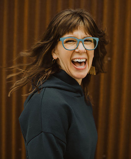 a lady with glasses laughing