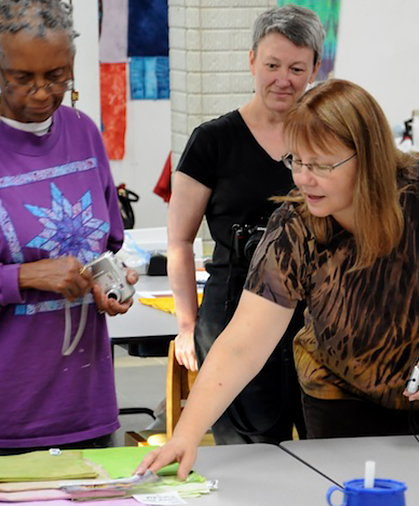 View of a woman explaining something to two women