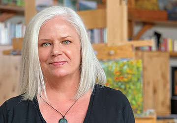 woman with a gray hair looking straight to the camera 