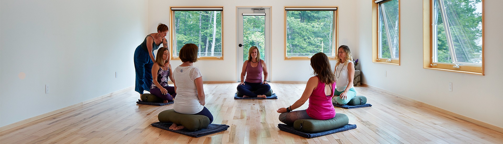 Internal view of a room with a group of people doing yoga