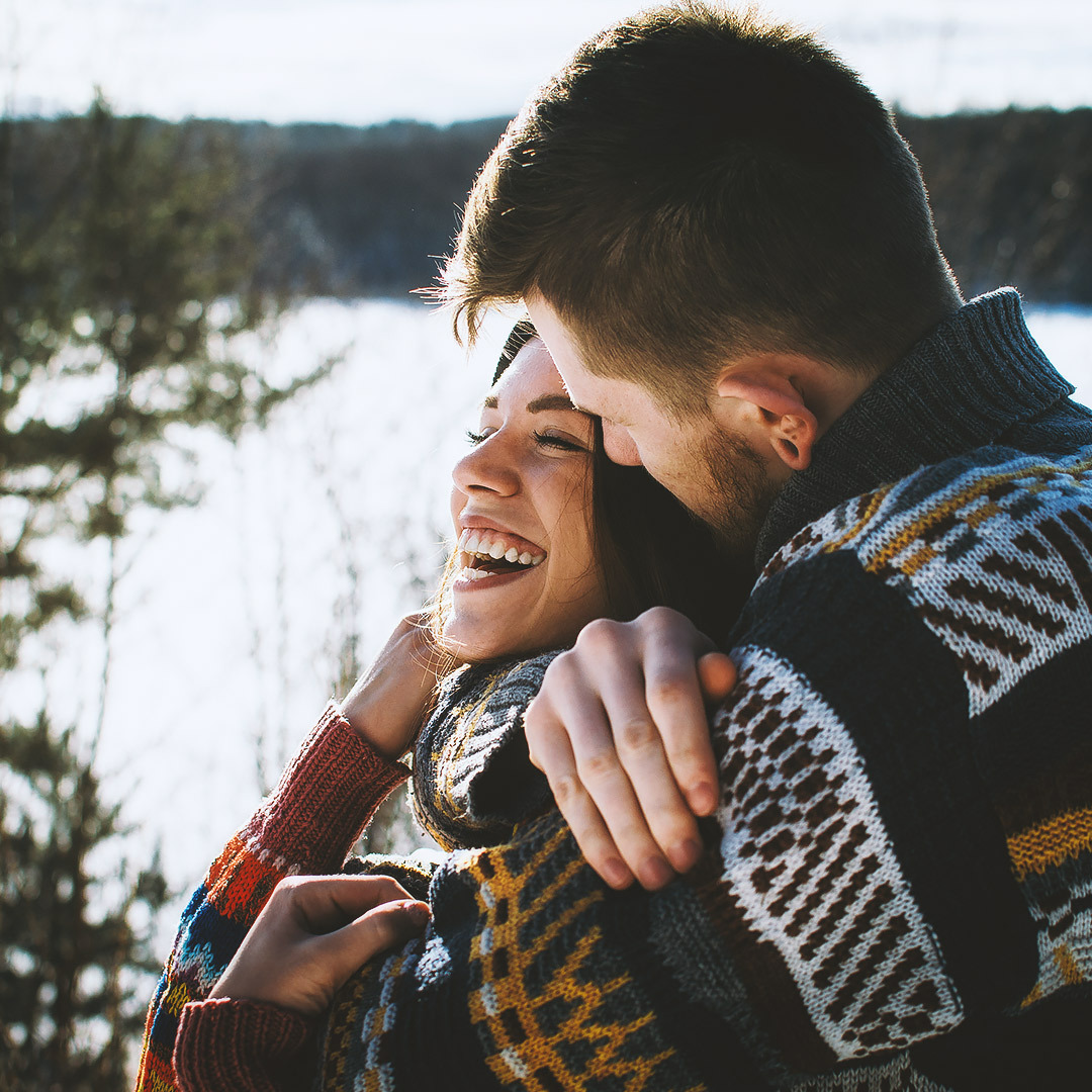 Cheerful couple embracing wearing sweaters