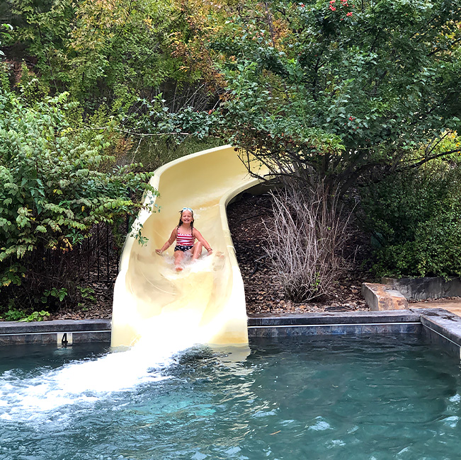 Wilderness Club Waterpark girl riding down the slide