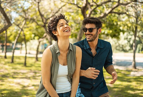 View of a man and a woman laughing outdoors