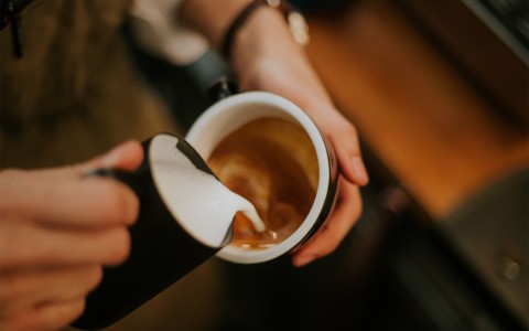 Top view of a cup of coffee with milk