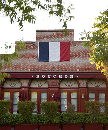 View of the Bouchon facade with the France flag standing at the entrance 
