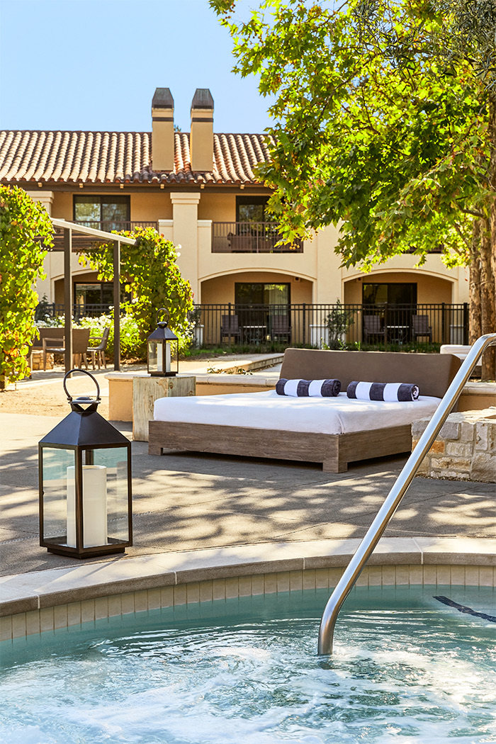 View of a big relaxing bed next to the pool