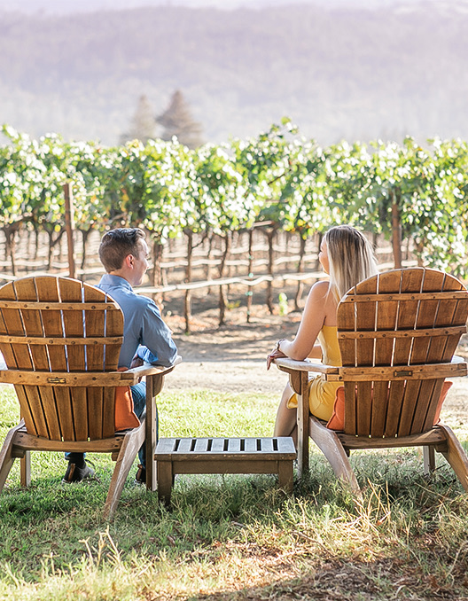 Back view of a couple sitting and enjoying the authentic wine country