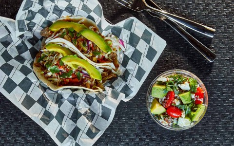 close up of tacos dish and a healthy fresh salad on the side