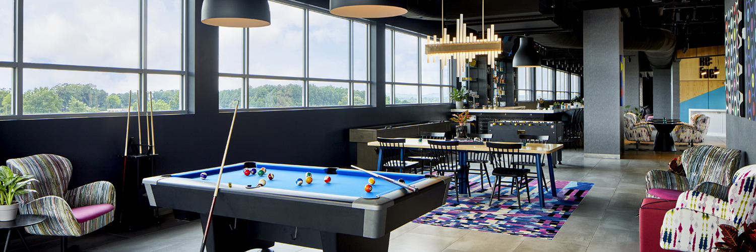 pool table alongside the big windows