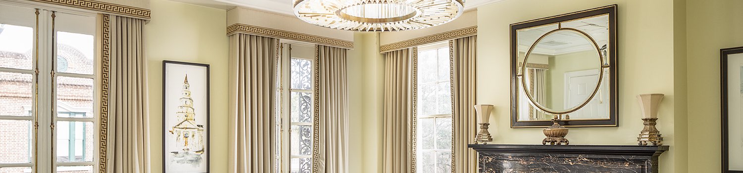 meeting room with a chandelier, tan curtains, and a fireplace mantle