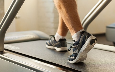 close up of a man using the treadmill