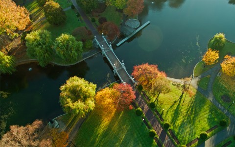 an aerial view of a small bridge that goes over the water