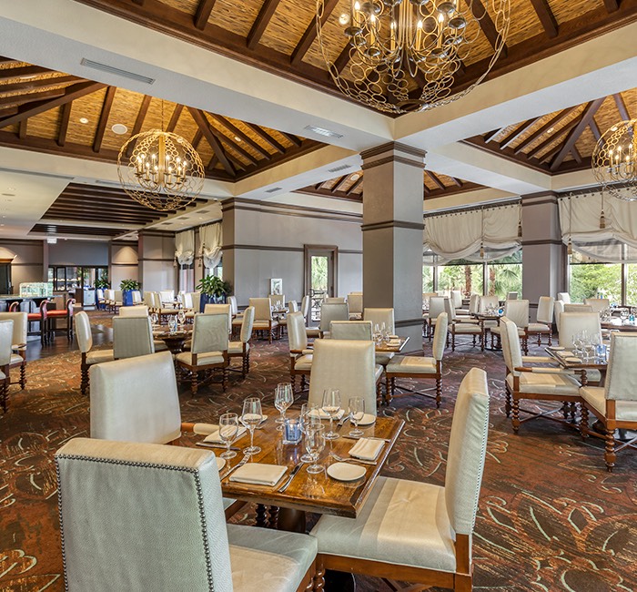 a large open dining room with exquisite light fixtures