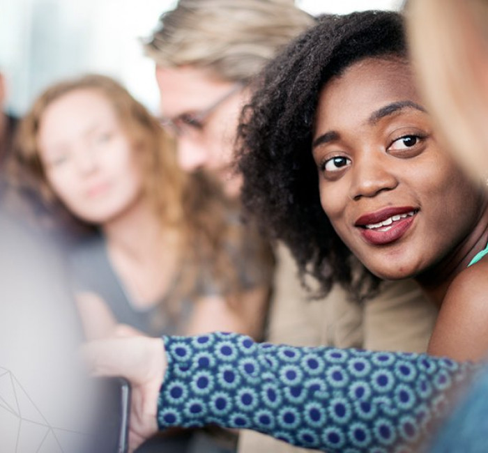 two women engaged in discussion at a meeting