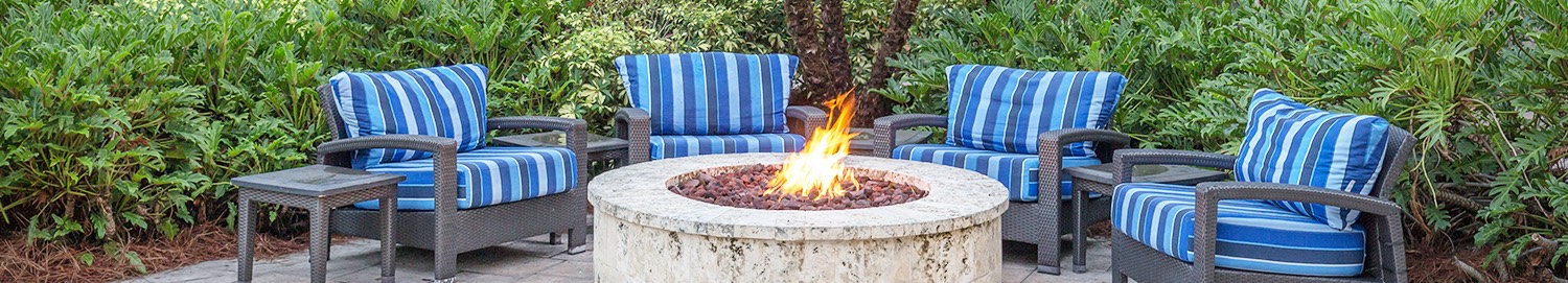 comfy sofa chairs surrounding a fire pit
