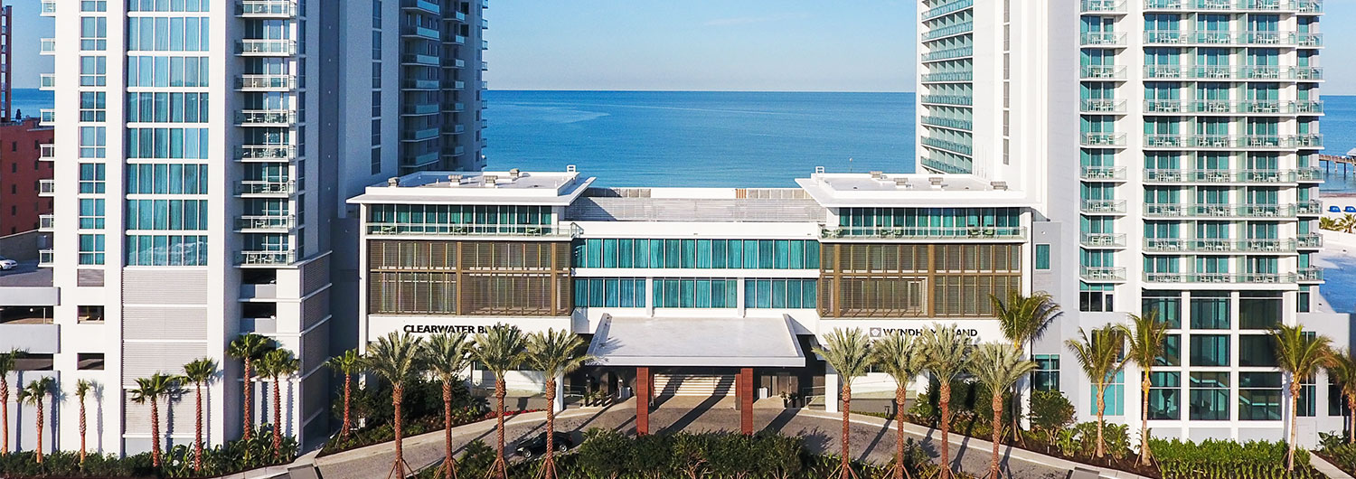 wide view of Wyndham Grand with ocean water view in the background