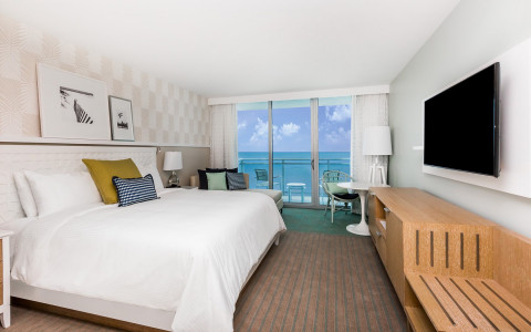 Roomw ith king bed, tv * seating area by balcony with beach view