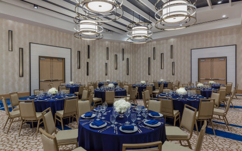 Meeting space with tables set with blue tablecloths