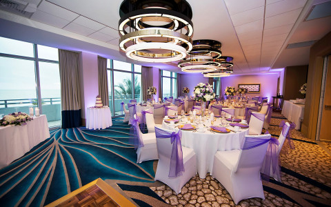 Room set for wedding reception with lilac accents