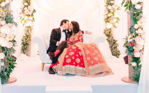 Wedding couple sitting on couch onstage