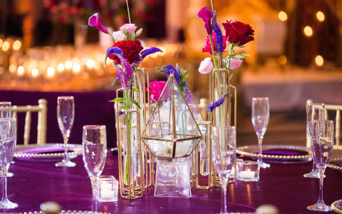 Close up of glasses on table with purple tablecloth