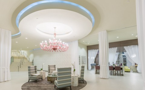 hotel lobby seating area under a large chandelier fixture