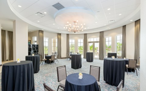 event space with black cloths on round chairs