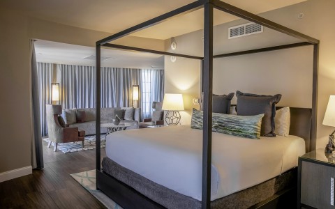 hotel room with king bed that has a princess bed frame