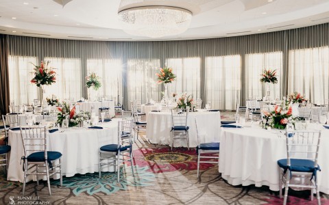wedding reception room with decorations and a crystal chandelier 