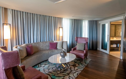 living room with purple and gray sofas