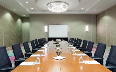 conference room with long rectangular table and papers on the table