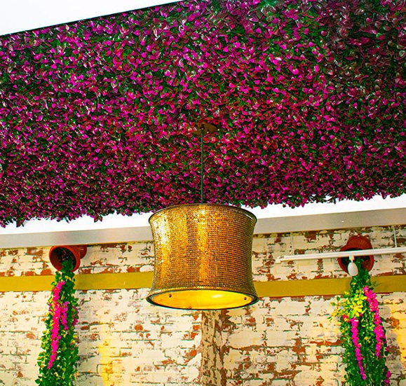 pink flowers hanging from restaurant ceiling 