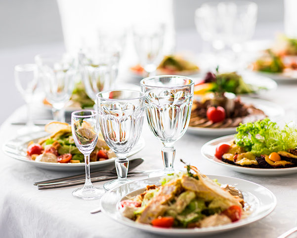 table set with plate of colorful foods and glassware