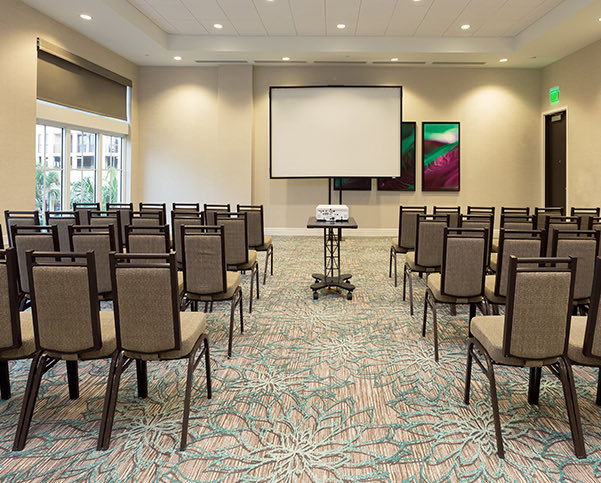 rows of chairs set for an event facing a projector