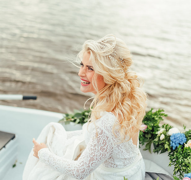 blonde bride sitting on a boat