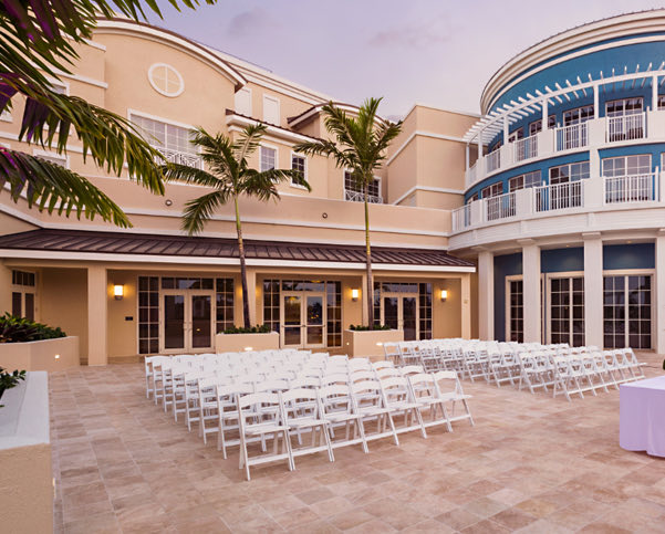 Rows of white chairs lined up for a wedding ceremony