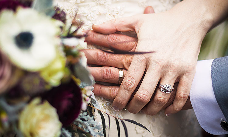 bride and groom holding hands