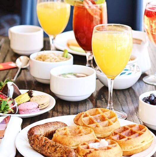 breakfast of waffles sausage and juice