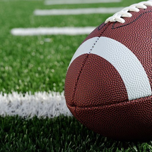 a football on an astro turf football field