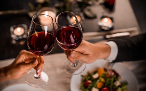 making a toast at an elegant dinner with red wine