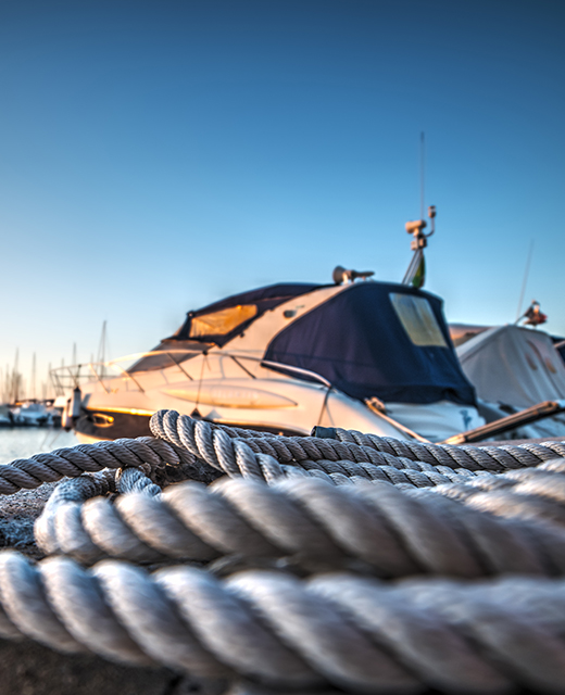 rope in focus with yachts in background