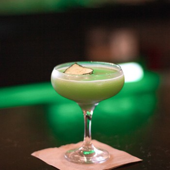 green cocktail on a napkin