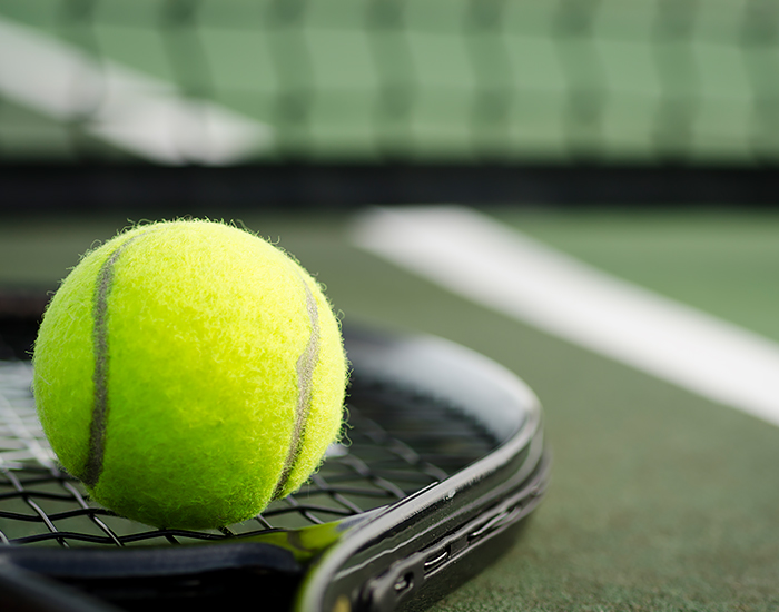 tennis ball on a racquet