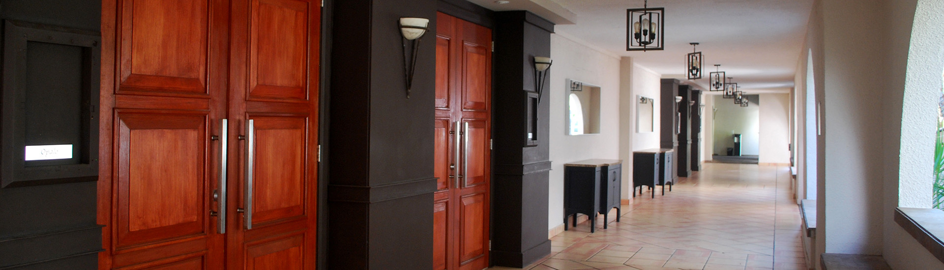 hallway with large mahogany doors
